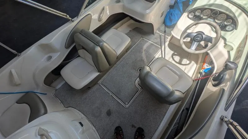 Slide: The Image of 2005 Sea Ray 180 Sport boat interior with seating and steering wheel. - 17