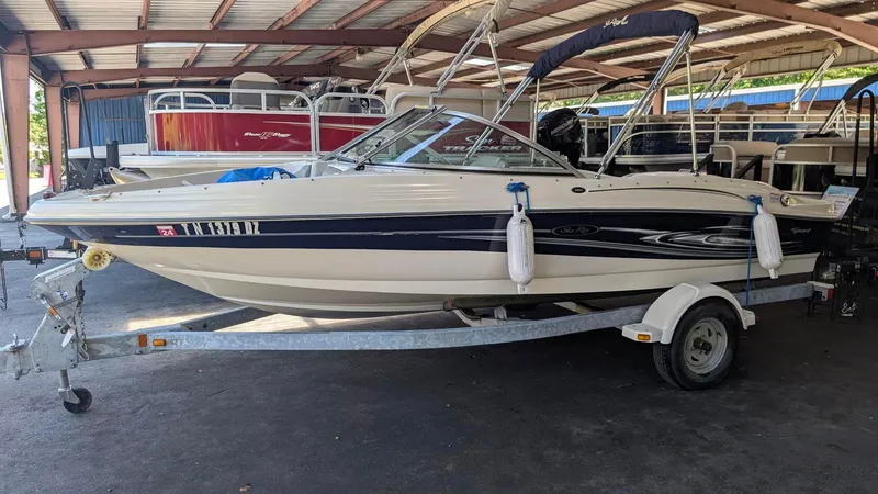 Slide: The Image of 2005 Sea Ray 180 Sport boat on trailer in covered storage area. - 18