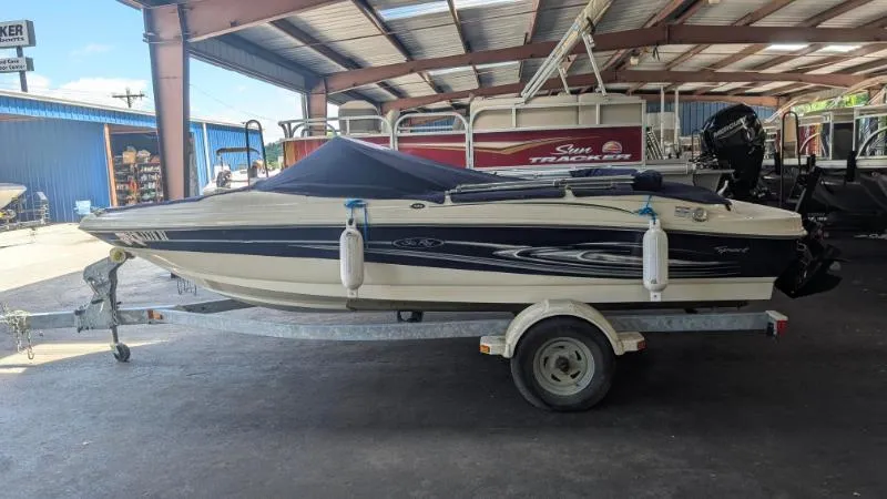 Slide: The Image of 2005 Sea Ray 180 Sport boat on trailer in covered storage area. - 21