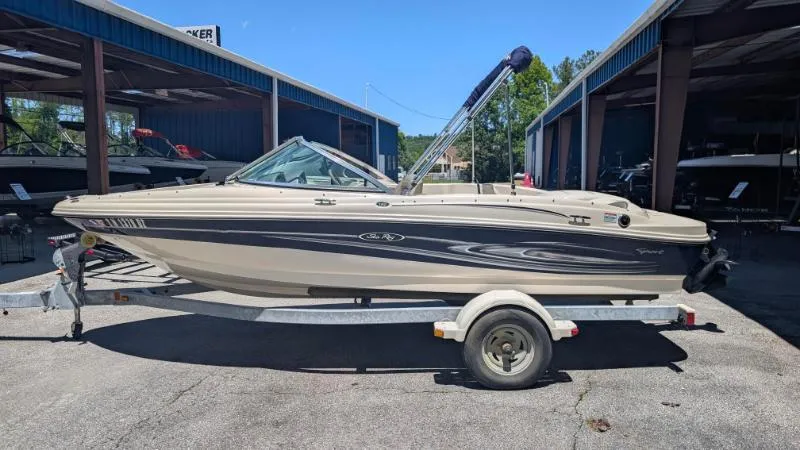 Slide: The Image of 2005 Sea Ray 180 Sport boat on trailer, parked outdoors near storage facility. - 22