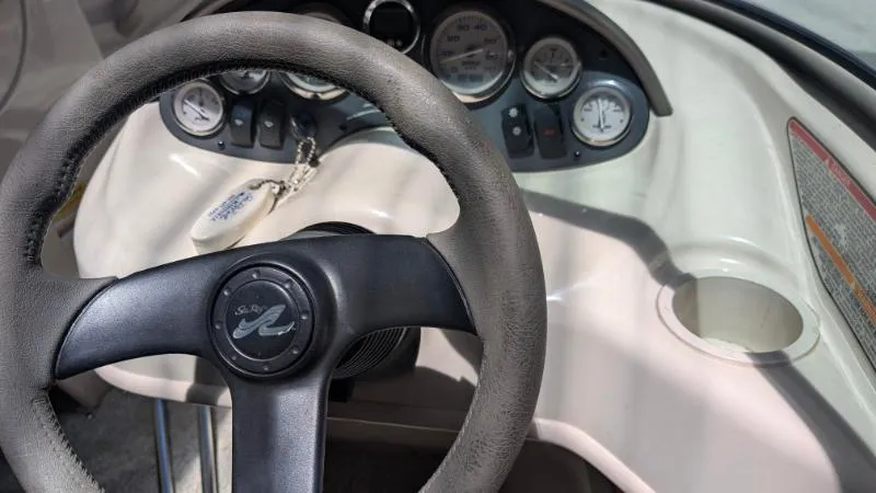 Slide: The Image of Steering wheel and dashboard of a 2005 Sea Ray 180 Sport boat. - 3