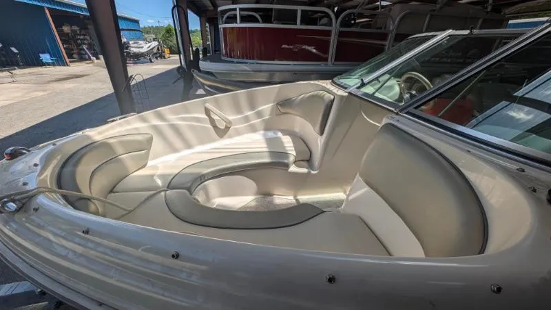 Slide: The Image of 2005 Sea Ray 180 Sport boat interior with beige seating and windshield. - 4