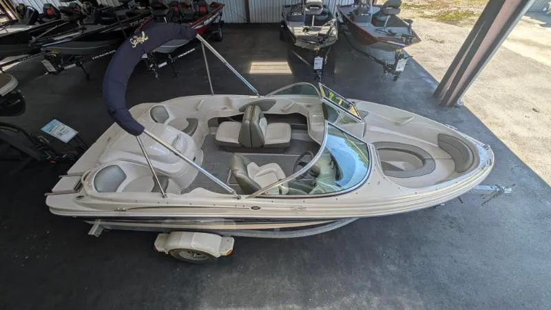 Slide: The Image of 2005 Sea Ray 180 Sport boat in storage, featuring a sleek design and spacious seating. - 5