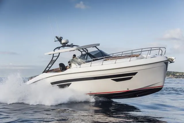 The Image of 2025 Oryx 379 boat cruising on open water, creating waves under a clear sky. - 0