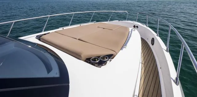 Slide: The Image of Luxury Oryx 379 yacht deck with sunbed, 2025 model, on calm ocean waters. - 14