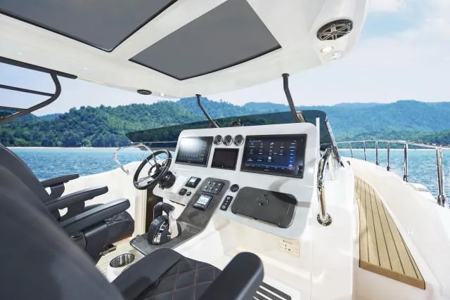 Slide: The Image of Luxury Oryx 379 yacht cockpit with advanced navigation systems, cruising on a serene lake. - 4