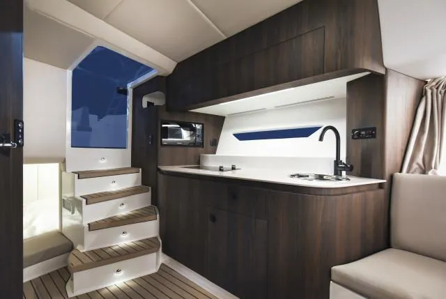 Slide: The Image of Luxurious interior of 2025 Oryx 379 yacht with modern kitchen and wooden finishes. - 7