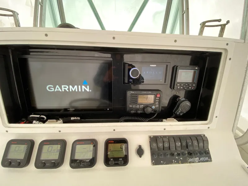 Slide: The Image of 2007 Regulator 29 Forward Seating boat dashboard with Garmin navigation system and control panel. - 11