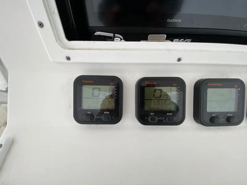 Slide: The Image of Control panel of a 2007 Regulator 29 Forward Seating boat with tachometer and speed displays. - 12