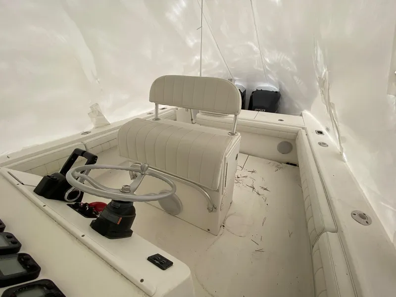 Slide: The Image of 2007 Regulator 29 Forward Seating boat interior with white upholstery and steering wheel. - 18