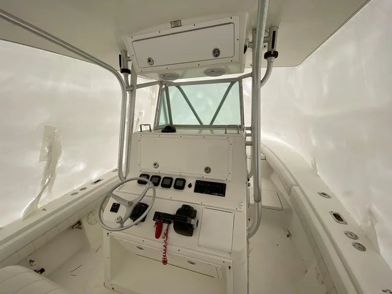 Slide: The Image of 2007 Regulator 29 Forward Seating boat interior with steering console and controls. - 19