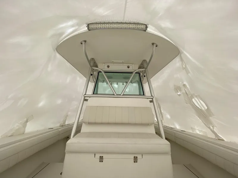 Slide: The Image of 2007 Regulator 29 Forward Seating boat interior with white upholstery and console. - 20