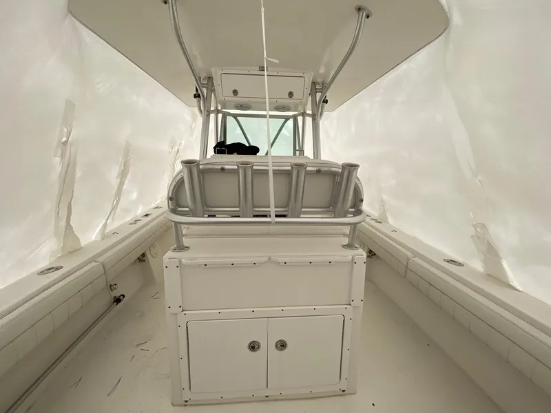 Slide: The Image of 2007 Regulator 29 Forward Seating boat interior with white upholstery and center console. - 21