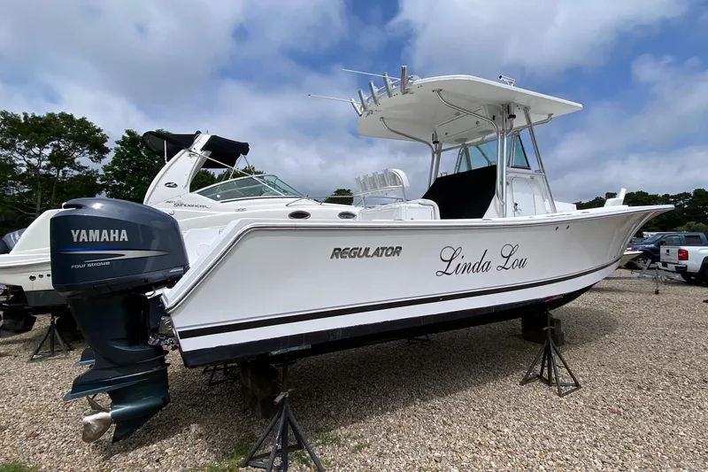 Slide: The Image of 2007 Regulator 29 Forward Seating boat with Yamaha engine on display outdoors. - 3