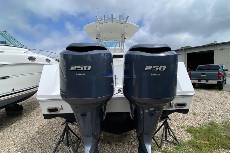 Slide: The Image of 2007 Regulator 29 Forward Seating boat with twin Yamaha 250 engines, docked outdoors. - 4