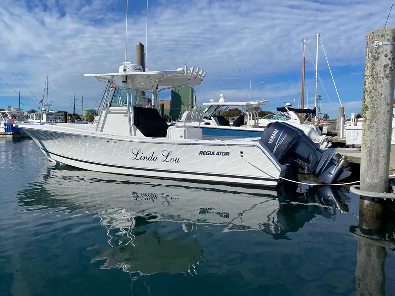 Slide: The Image of 2007 Regulator 29 Forward Seating boat docked in marina, featuring twin Yamaha engines. - 6