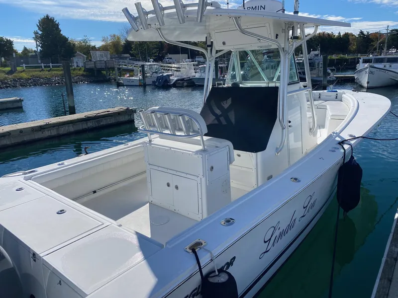 Slide: The Image of 2007 Regulator 29 Forward Seating boat docked in a marina, featuring a spacious deck. - 8