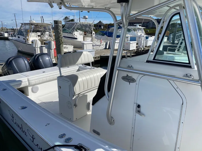 Slide: The Image of 2007 Regulator 29 Forward Seating boat docked, featuring dual engines and spacious seating. - 9