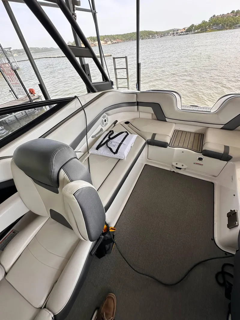 Slide: The Image of 2020 Yamaha AR240 boat interior with seating, overlooking a serene water view. - 1