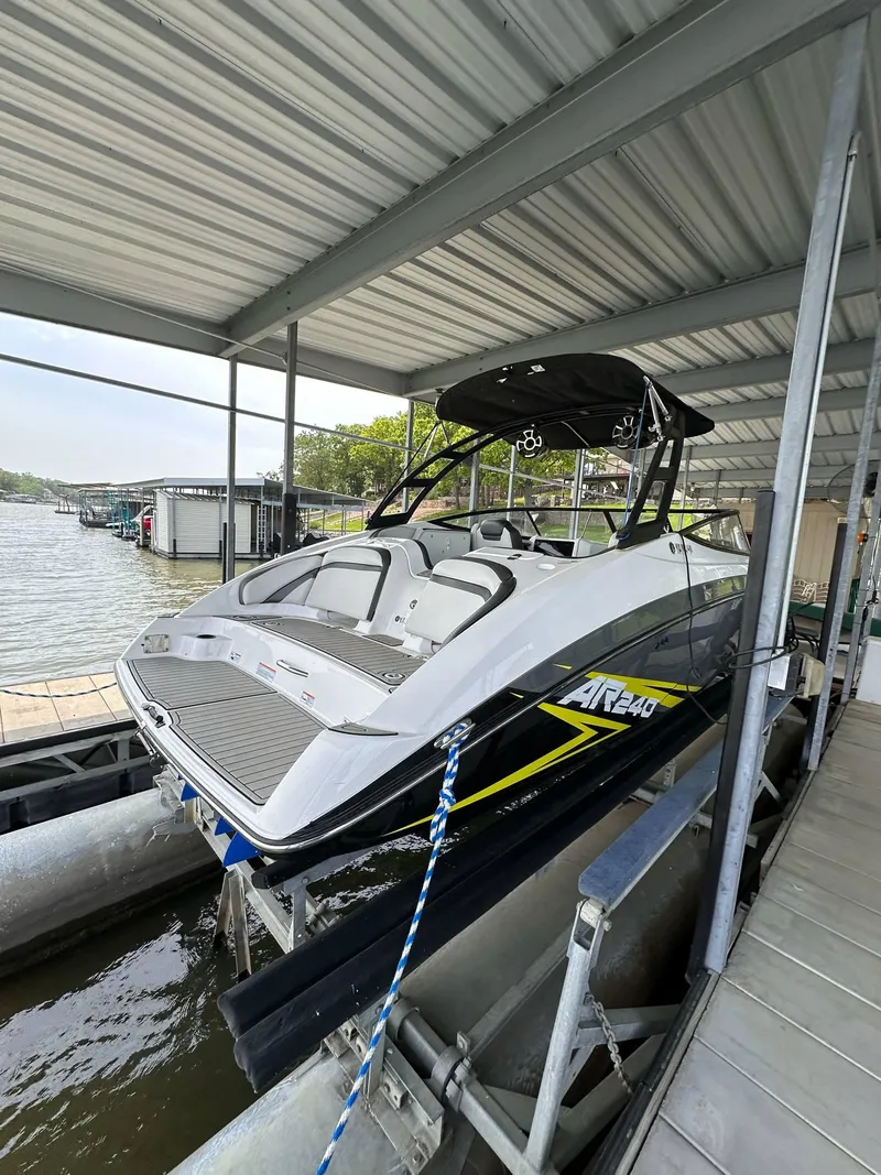 Slide: The Image of 2020 Yamaha AR240 boat docked under a covered marina. - 10
