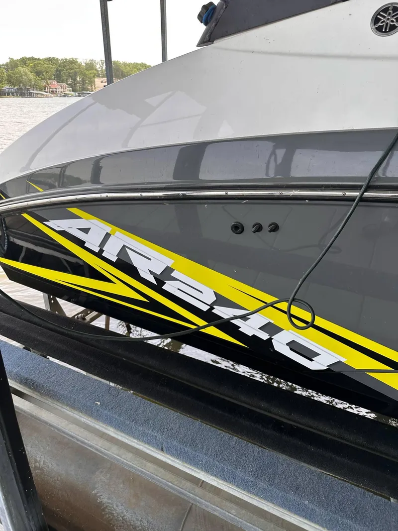 Slide: The Image of 2020 Yamaha Boats AR240 with sleek design and bold graphics on the water. - 11
