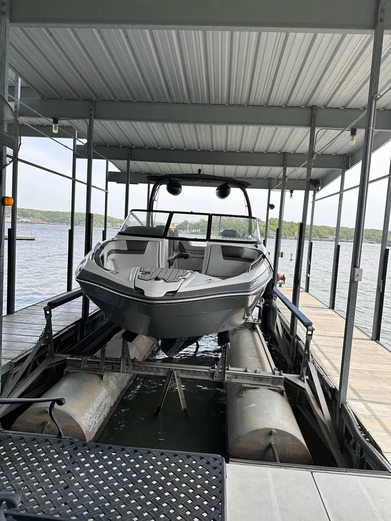 Slide: The Image of 2020 Yamaha Boats AR240 docked in a covered marina slip. - 12