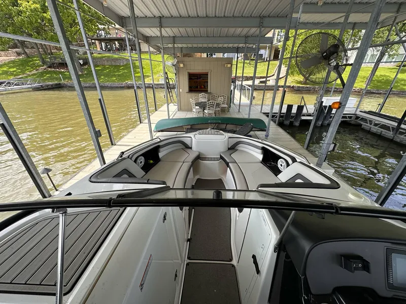 Slide: The Image of 2020 Yamaha Boats AR240 docked under a covered pier with seating area. - 5