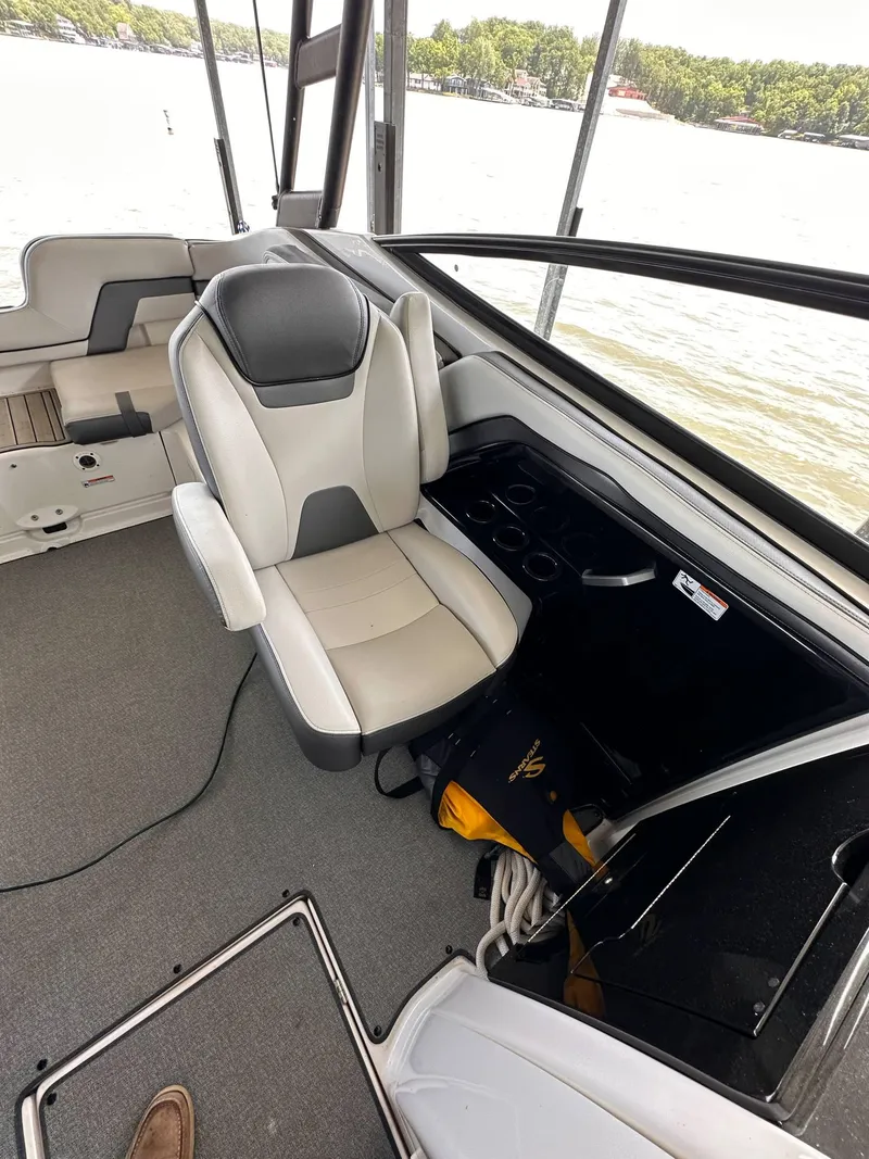 Slide: The Image of 2020 Yamaha Boats AR240 interior with captain's chair and dashboard, overlooking water. - 6