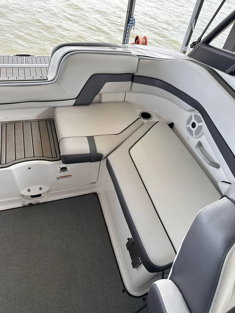 Slide: The Image of 2020 Yamaha AR240 boat interior with cushioned seating and sleek design. - 8