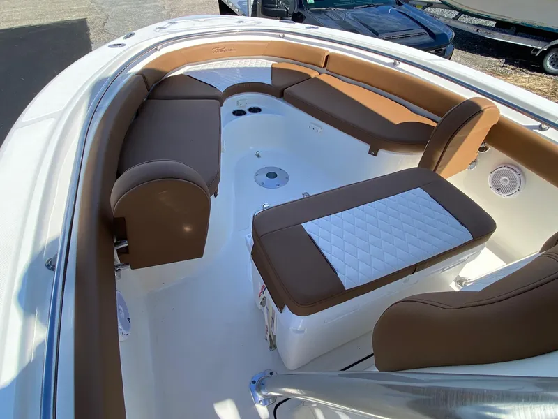 Slide: The Image of 2025 Pioneer 222 Islander boat interior with brown and white seating, showcasing modern design. - 10