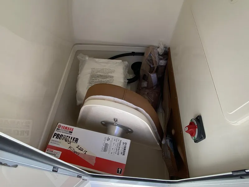 Slide: The Image of Storage compartment in 2025 Pioneer 222 Islander boat with Yamaha propeller box and accessories. - 11