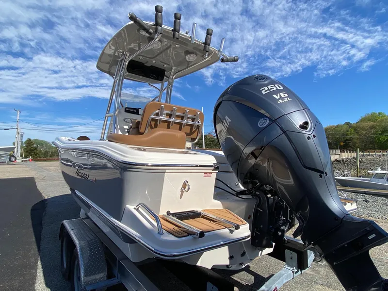 Slide: The Image of 2025 Pioneer 222 Islander boat with powerful 250 V6 engine on trailer under blue sky. - 3