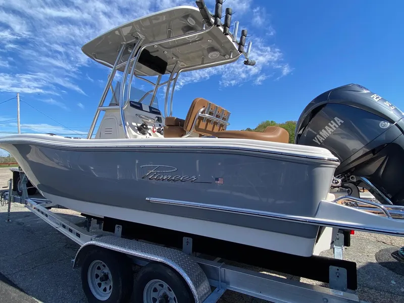 Slide: The Image of 2025 Pioneer 222 Islander boat on trailer with Yamaha engine under clear blue sky. - 4