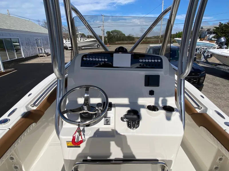 Slide: The Image of 2025 Pioneer 222 Islander boat console with steering wheel and controls. - 5