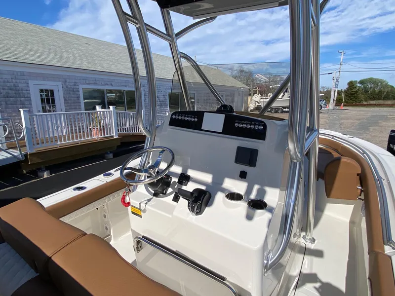 Slide: The Image of 2025 Pioneer 222 Islander boat interior with steering console and seating. - 7