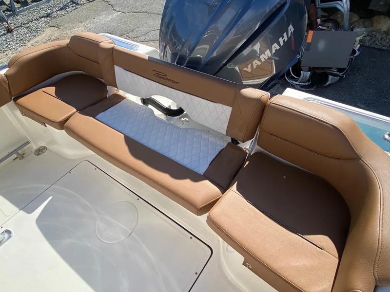 Slide: The Image of 2025 Pioneer 222 Islander boat seating with Yamaha engine, featuring brown and white cushioned seats. - 9