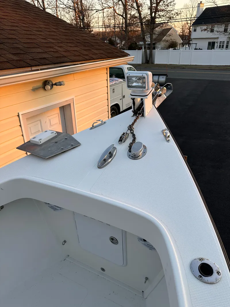 Slide: The Image of 2015 Allied 17 Explorer boat parked near a garage at sunset. - 11