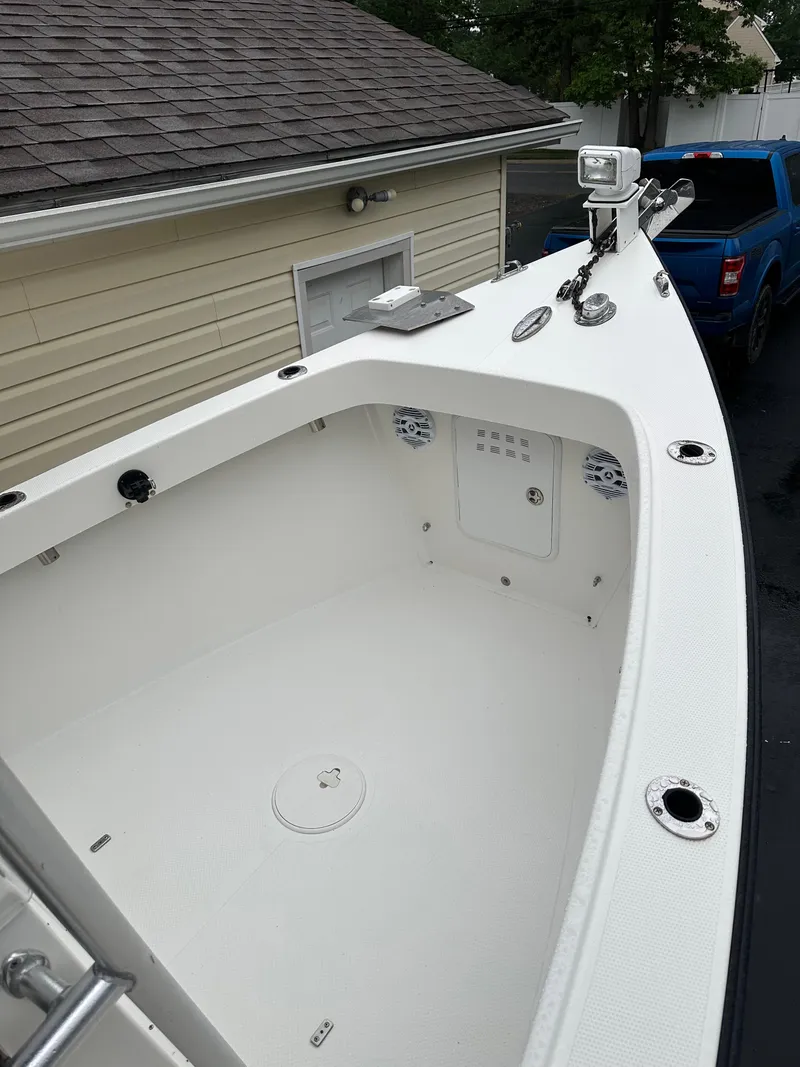 Slide: The Image of 2015 Allied 17 Explorer boat, white interior, parked near a house and blue truck. - 12