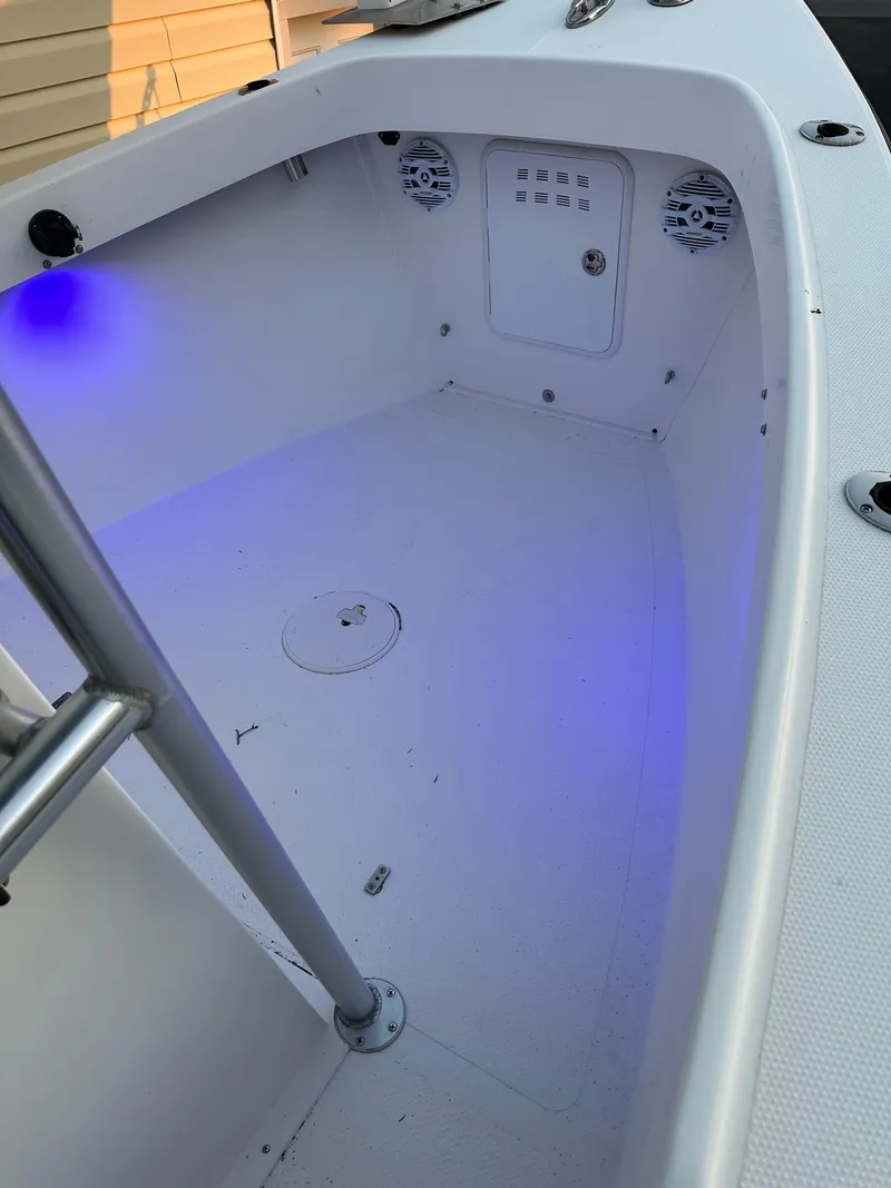 Slide: The Image of 2015 Allied 17 Explorer boat interior with blue LED lighting and storage compartments. - 14