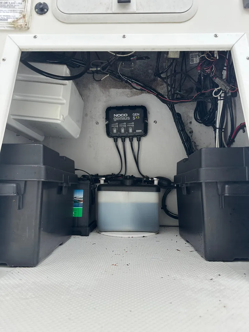 Slide: The Image of Electrical setup inside a 2015 Allied 17 Explorer boat, featuring battery boxes and wiring. - 22