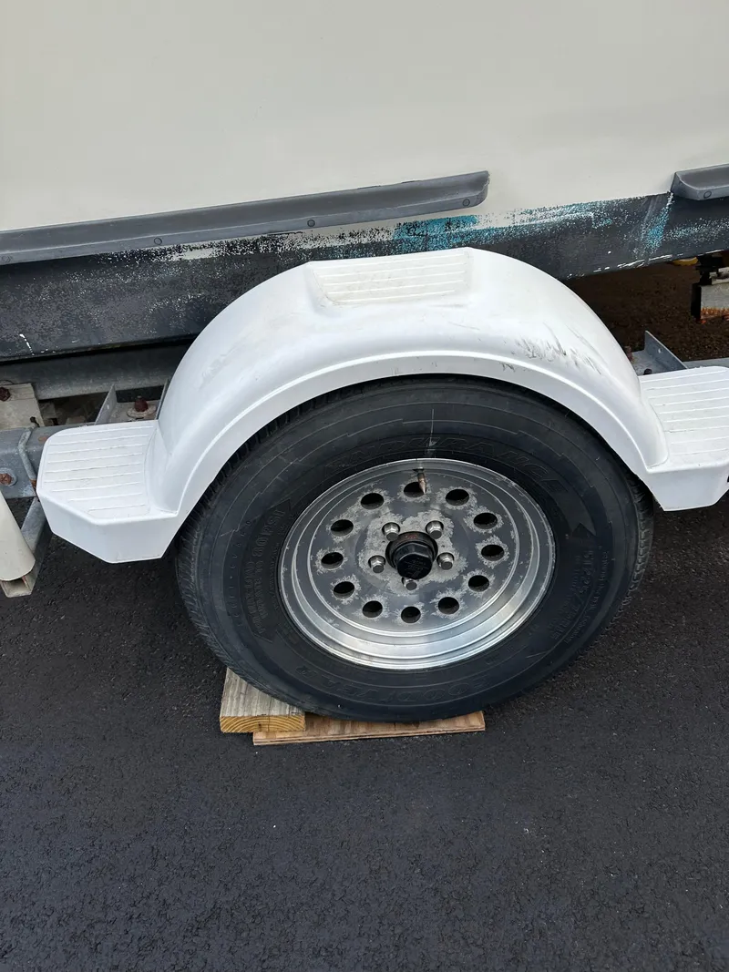 Slide: The Image of Trailer wheel of a 2015 Allied 17 Explorer on a wooden block. - 28