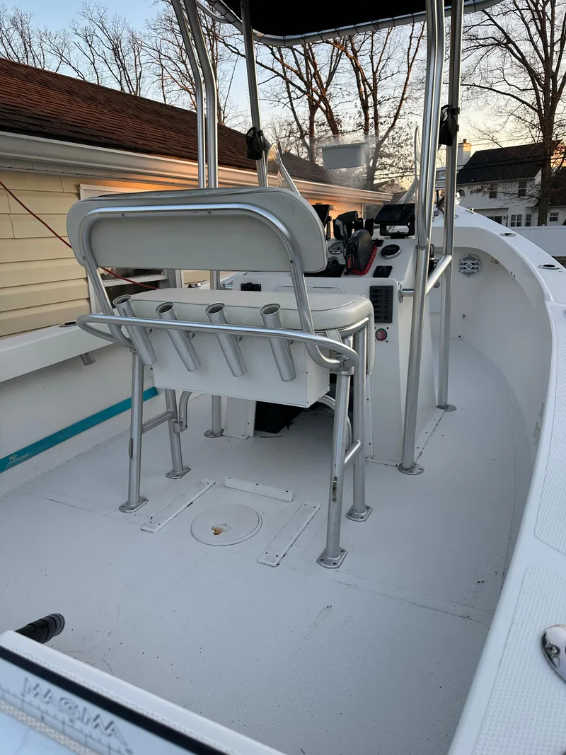 Slide: The Image of 2015 Allied 17 Explorer boat with center console and seating, docked near a house. - 9