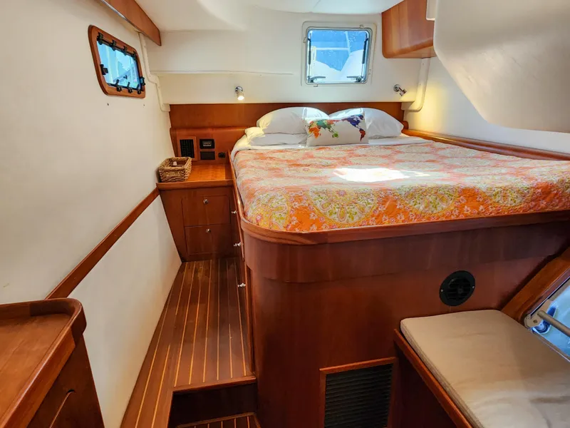 Slide: The Image of Cozy cabin interior of 2014 Antares 44i yacht with bed and wooden furnishings. - 16