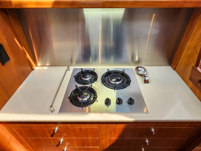 Slide: The Image of Stainless steel three-burner stove in 2014 Antares 44i yacht kitchen. - 19