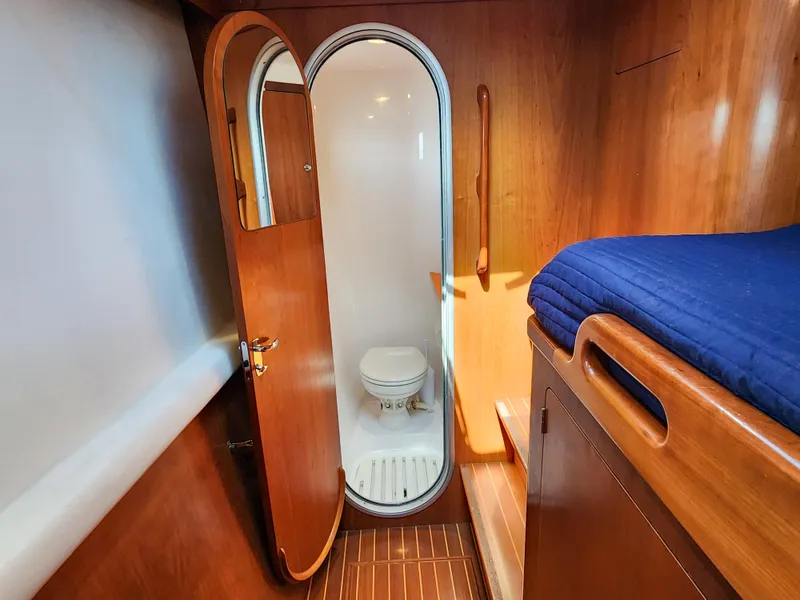 Slide: The Image of 2014 Antares 44i yacht interior with wooden cabin and compact bathroom. - 27