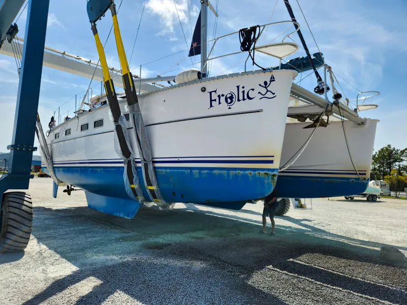 Slide: The Image of Antares 44i catamaran named "Frolic" being lifted, 2014 model, in a boatyard. - 3