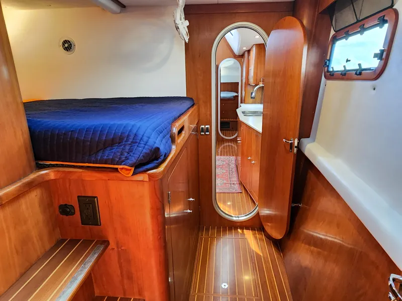 Slide: The Image of Luxurious 2014 Antares 44i yacht interior with wooden finish and cozy sleeping area. - 30