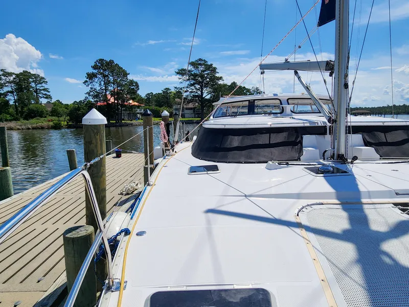 Slide: The Image of 2014 Antares 44i yacht docked by a scenic waterfront with clear blue skies. - 32
