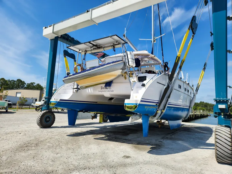 Slide: The Image of 2014 Antares 44i catamaran lifted by crane in a boatyard. - 4