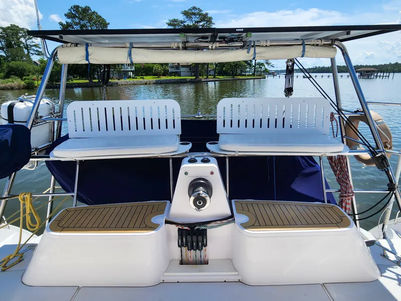 Slide: The Image of 2014 Antares 44i yacht deck with seating, overlooking serene water and lush greenery. - 43